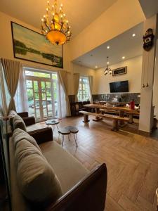 a large living room with a couch and a pool table at De Daisy Villa Homestay in Da Lat