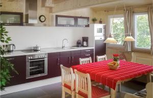 a kitchen with a table with a red table cloth at Beautiful Home In Turrach With 4 Bedrooms And Internet in Turracher Hohe