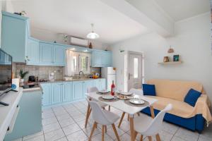 a kitchen and a living room with a table and chairs at Militsa House in Gaios