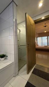 a bathroom with a shower and a glass door at شقة فاخرة بإطلالة بحرية كاملة in Jeddah