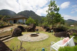 a house with a garden with a fire pit in the yard at Thumpers Cottage in Kalawana