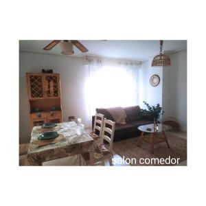 a living room with a table and a couch at TXIMELETA Haro in Haro