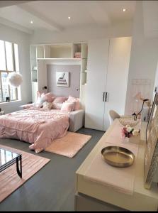 a bedroom with a pink bed and a desk at LITTLE HAVEN in Newark