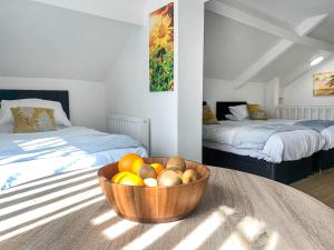 a bowl of fruit on a table in a room with two beds at Highmead - Uk46951 in Blackwood