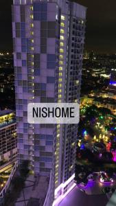 een nachtzicht op een hoog gebouw met het woord nitzphrine bij Homestay Murah Icity Shah Alam Duplex in Shah Alam