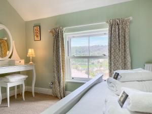 a bedroom with a bed and a window at Rock Terrace View in Bakewell