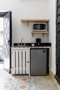 a kitchen with a sink and a microwave at PLENO CENTRO MERIDA ESTUDIO3 CASA PAXI in Mérida