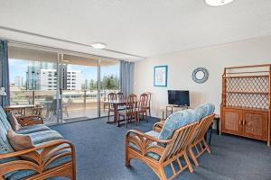 a living room with a couch and chairs and a television at Wyuna - Walking distance to burleigh in Gold Coast