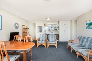 a living room with a table and chairs at Wyuna - Walking distance to burleigh in Gold Coast