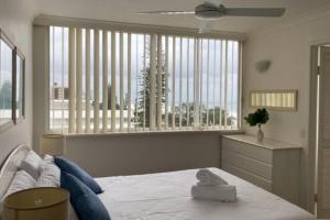 a bedroom with a bed and a large window at Ocean Front 2Bed - Unbeatable Views @ Sanderling! in Gold Coast