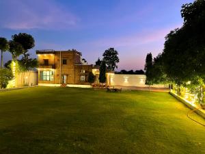 a large yard in front of a house at night at Poonam Palace jodhpur in Jodhpur