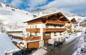 a large building with cars parked in the snow at Beautiful Apartment In Grossarl With 2 Bedrooms And Wifi in Grossarl