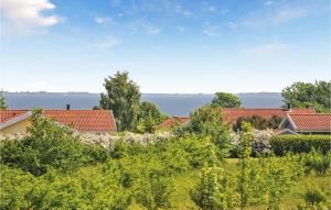a view of houses and trees with the water in the background at Holiday Home Fiskervej Sydals Xii in Skovby