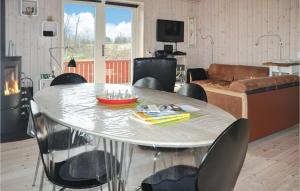 a living room with a round table and chairs at Holiday Home Fiskervej Sydals Xii in Skovby +12 photos