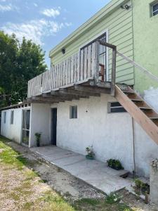 a house with a staircase on the side of it at Alojamiento Tres Lunas Triple in Chuy