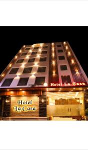 Hotel La Casa Amritsar Near ISBT & Golden Temple في أمريتسار: مبنى مع فندق ag cason في الليل