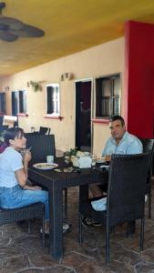 two people sitting at a table in a restaurant at Hostal ROCA INN in Mazatlán
