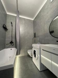 a bathroom with a washing machine and a sink at Больница Управ делами президента , IT Университет, Центр репродукции, Экспо Mega Silkway, Аэропорт in Prigorodnyy