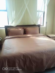 Ένα ή περισσότερα κρεβάτια σε δωμάτιο στο VILLA FIORI APARTMENTS