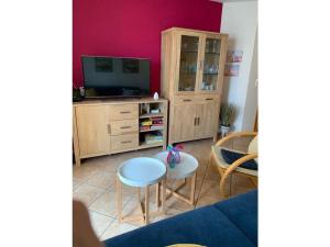 a living room with a tv and a table at Wood in Zempin Usedom in Zempin