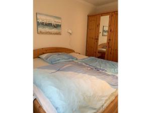a bedroom with a large bed with a wooden frame at Wood in Zempin Usedom in Zempin