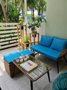 a patio with a blue couch and a table at Holiday Escape Philippines in Manila