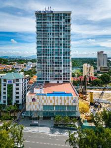 a tall building with a sign on top of it at Nhà Của Thóc - CSJ Tower Vũng Tàu in Vung Tau