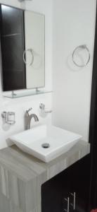 a bathroom with a white sink and a mirror at Un departamento a tu gusto in Valladolid