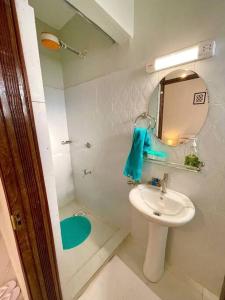a white bathroom with a sink and a mirror at B&M homes, ensuite 2 bedrooms Meru in Meru