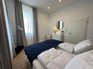 a bedroom with a large bed and a window at SHINY HOMES - Bielefeld Mitte in Bielefeld
