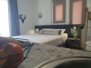 a bedroom with a bed with a basketball in a basket at Olea Luxury Suites in Asprovalta