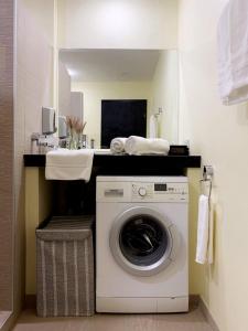 a washing machine in a bathroom with a sink at Klong Son Beachfront Apartments in Ko Chang