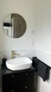 a bathroom with a white sink and a mirror at Voyage in Kehl am Rhein