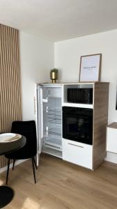 a kitchen with an oven and an open refrigerator at Voyage in Kehl am Rhein