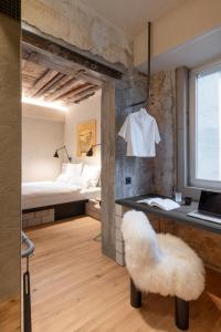 a room with a bed and a desk with a chair at B5 Boutique Hotel - NEW OPENING in Lugano