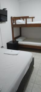 a bedroom with two bunk beds and a television at Hotel Río Mar in Cartagena de Indias