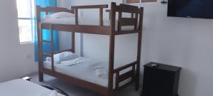 two bunk beds in a room with a tv at Hotel Río Mar in Cartagena de Indias