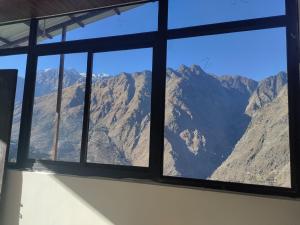 a view of a mountain view from a window at Singhdwar Homestay in Joshīmath