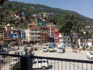 a city with cars parked in a parking lot at Singhdwar Homestay in Joshīmath