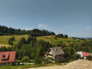 an old house on top of a hill at Gładyszówka - Chatka w Gorcach in Ponice