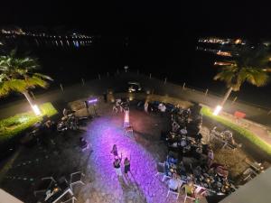 an overhead view of a crowd of people at night at as sifah in Muscat