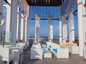 a row of white tables and chairs on a balcony at as sifah in Muscat