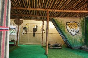 a tent with a painting of a tiger and penguins at Dhalpur Homestay 