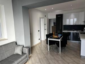 a living room and kitchen with a table and a couch at Casa Simone in Omegna