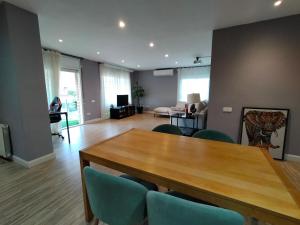 ein Wohnzimmer mit einem Holztisch und Stühlen in der Unterkunft Apartamento Familiar in Cambrils