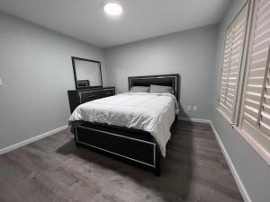 a bedroom with a bed and a mirror and a window at Entire 3 BR & 2 BA house for business and family in Modesto +13 photos