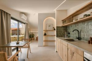 a kitchen with a sink and a table and a dining room at Veranda Suite in Argostoli