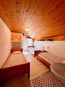 Saas-BalenにあるHoliday House Lärchenheimのベッド2台とシンクが備わる広い客室です。
