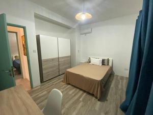 a small bedroom with a bed and a mirror at 3 bedroom private villa in calm area in Grand Baie