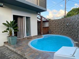 a swimming pool in the backyard of a house at 3 bedroom private villa in calm area in Grand Baie